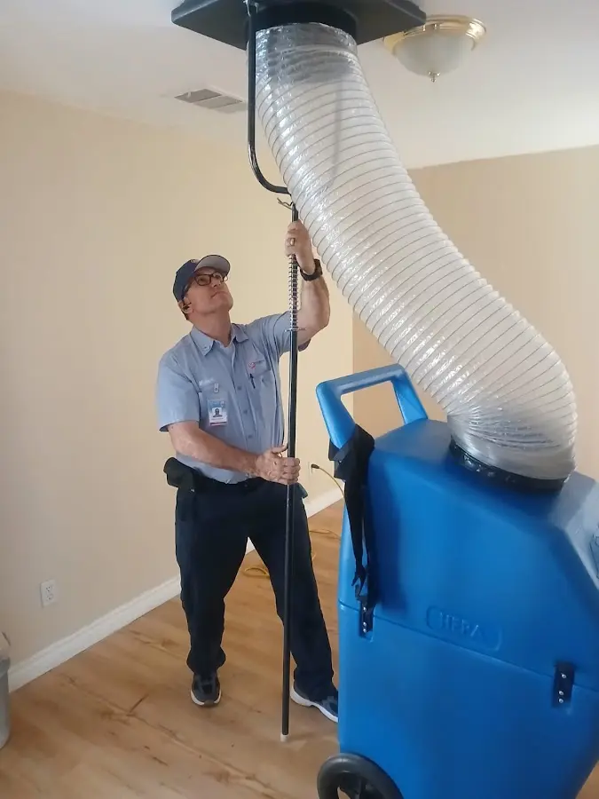 Furnace Tune-Up technician using HEPA equipment in Garden City